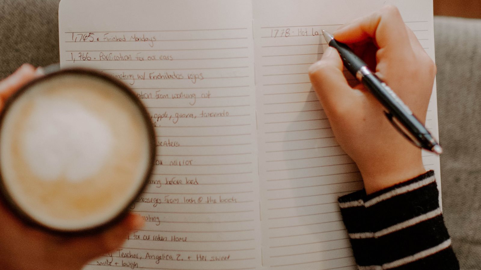 A close-up of a notebook with several days of short handwritten entries visible, conveying the act of reviewing past notes to find patterns.