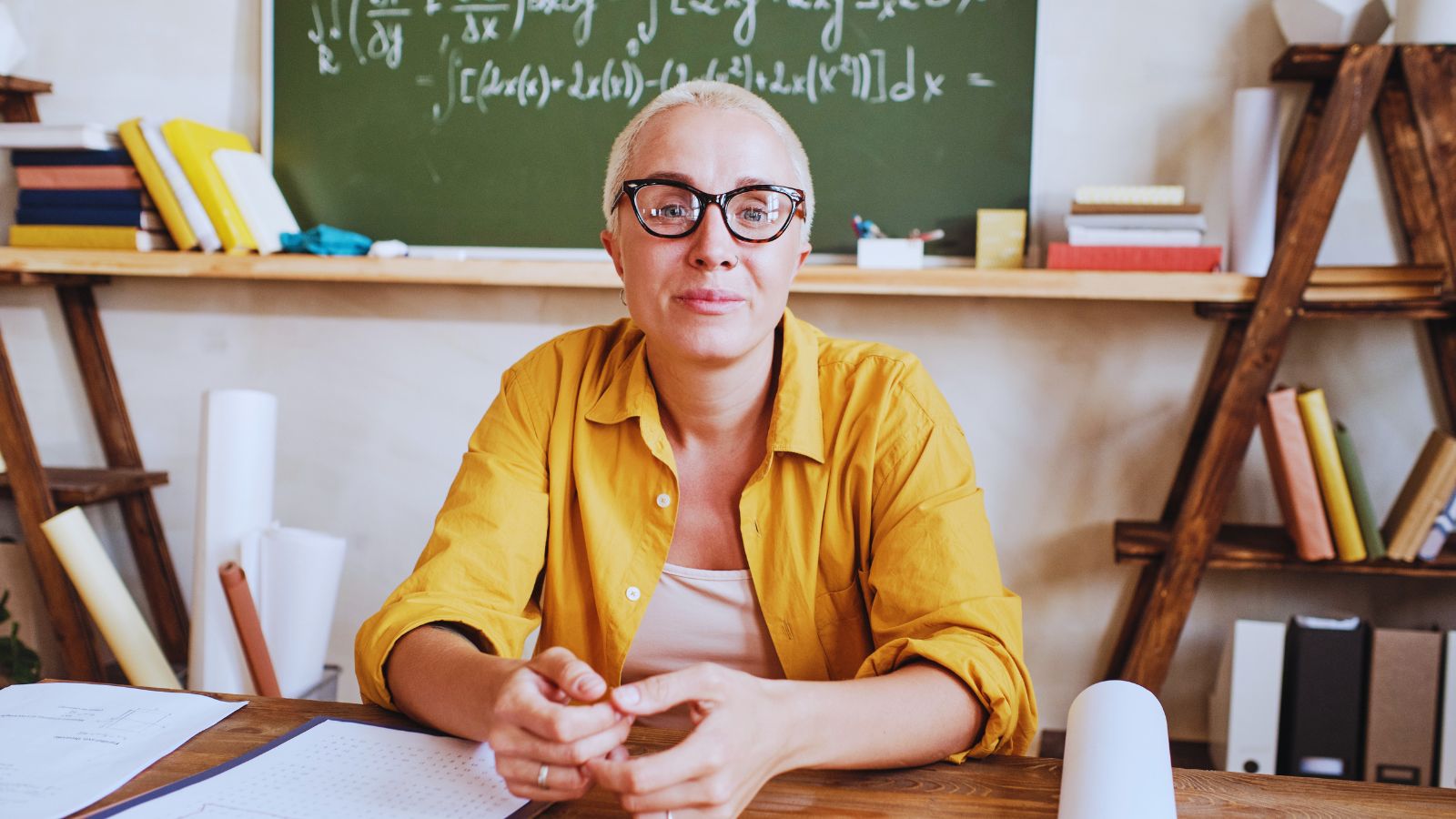 A teacher sitting at a desk.