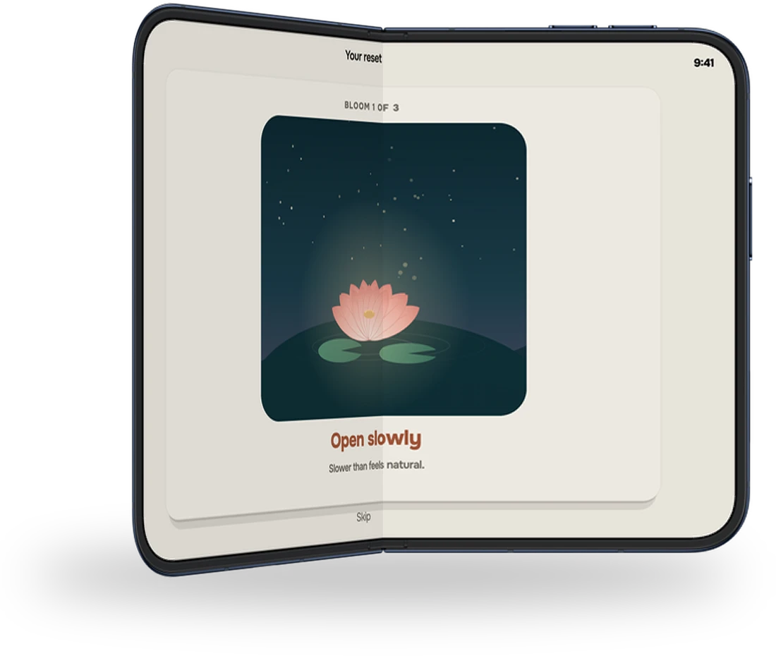 Slow Bloom on iPhone Duo held half open like a book, a lotus starting to open
